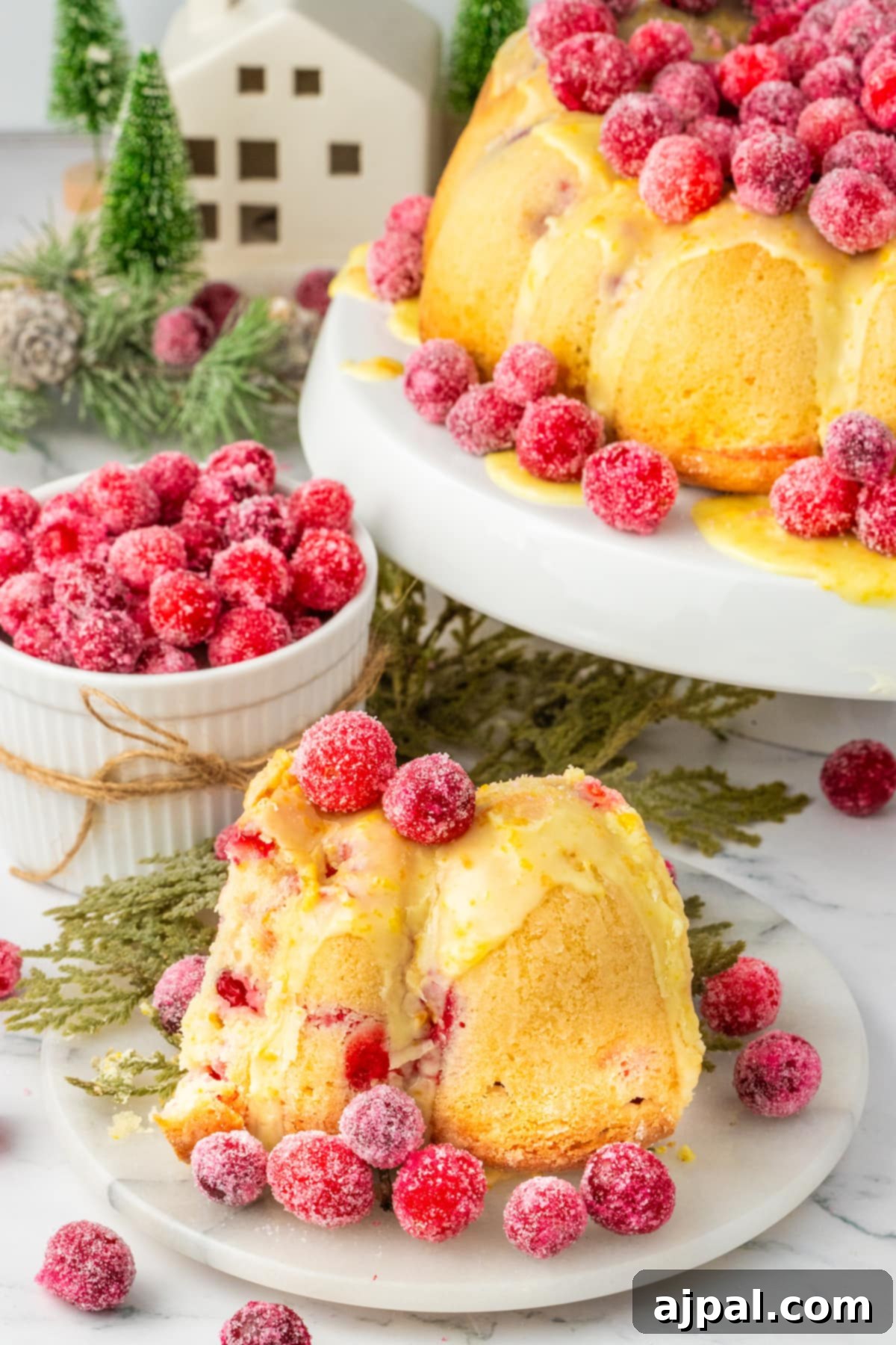 Bright Cranberry Orange Bundt Cake 2 A festive orange bundt cake adorned with candied cranberries, with a few extra berries scattered on the side.