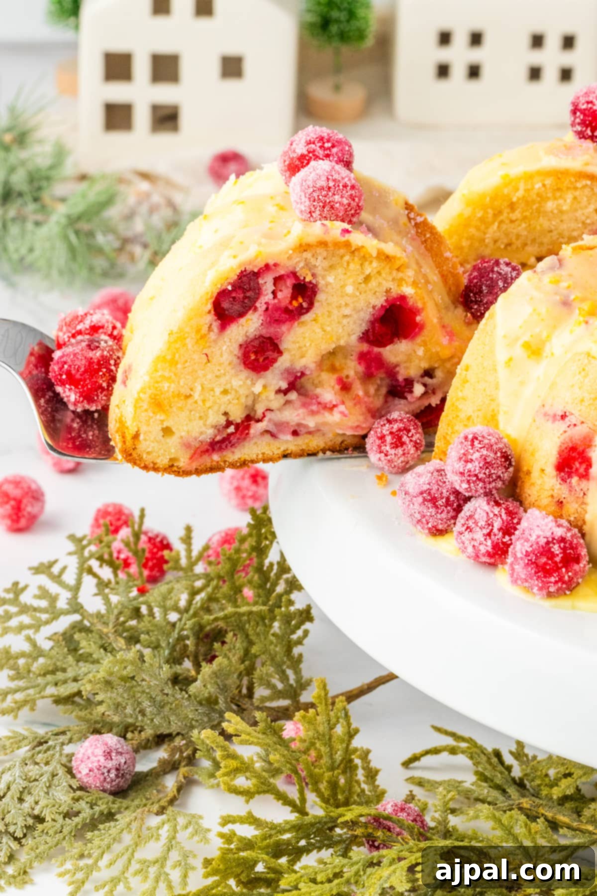 Bright Cranberry Orange Bundt Cake 16 A beautiful Cranberry Orange Bundt Cake elegantly displayed on a plate with a fork, ready to be enjoyed.