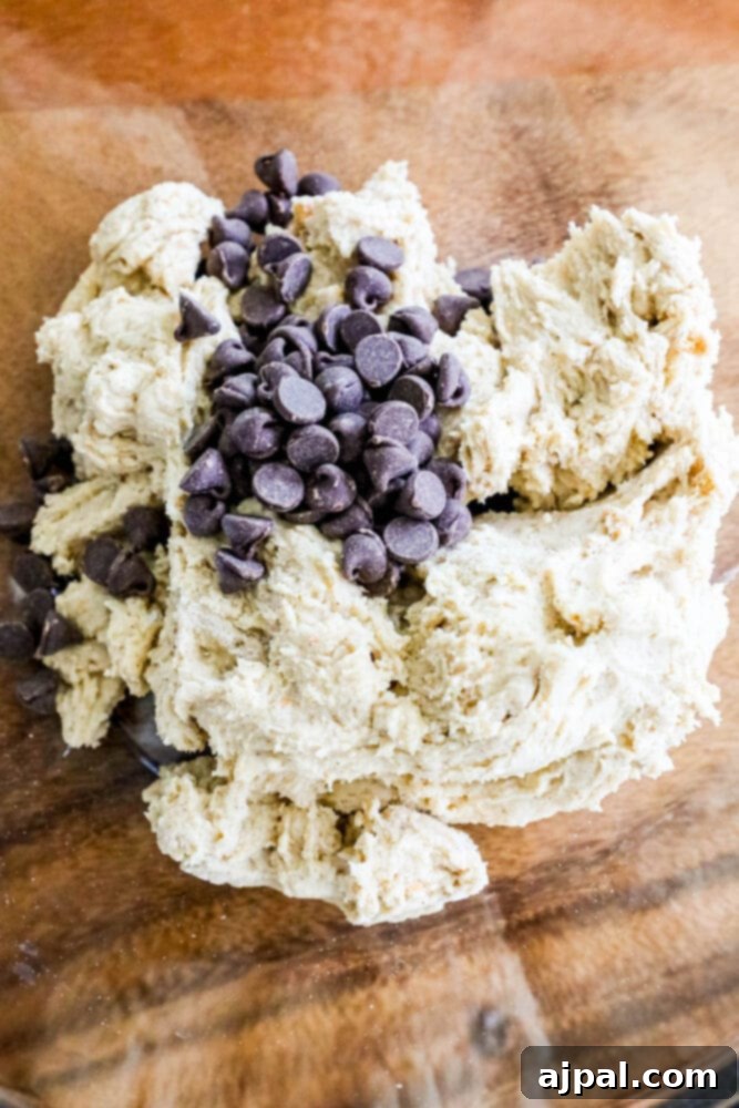 Gluten-Free S'mores Cookies 5 Gluten-free chocolate chip cookie dough on a wooden plate reminiscent of campfire cookies.