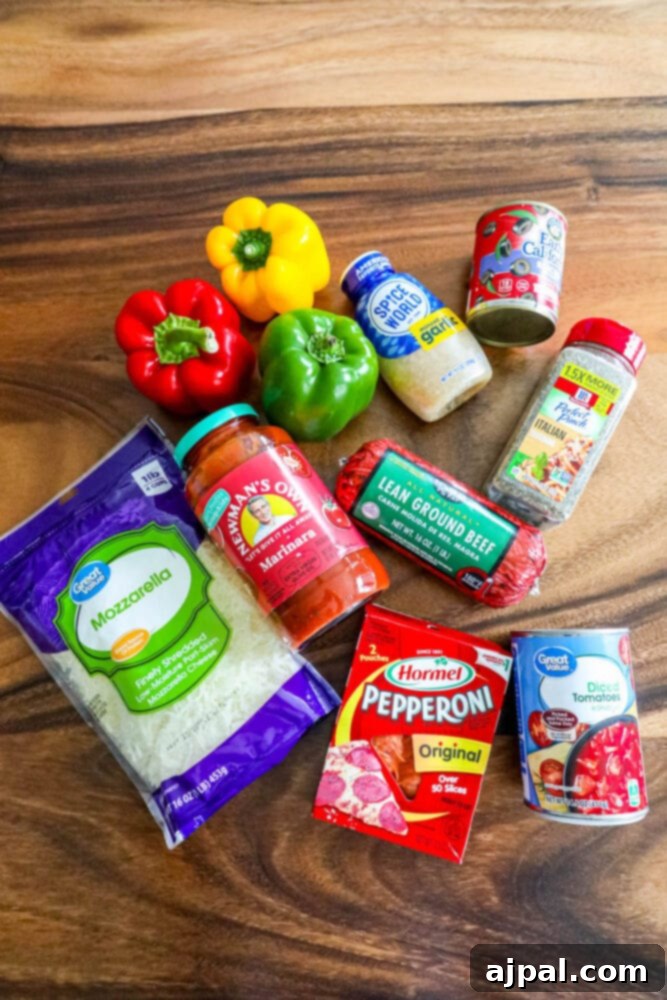 Pepper Pizzas 5 Assorted raw ingredients including bell peppers, ground beef, and cheeses laid out on a wooden table, ready for preparing pizza stuffed peppers.