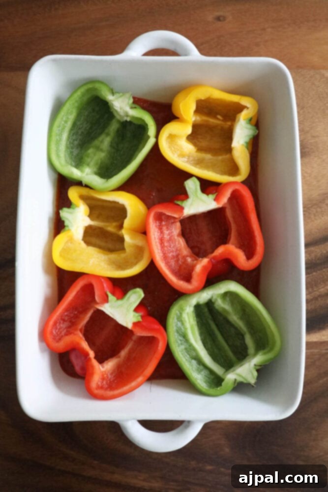 Pepper Pizzas 6 Prepared bell pepper halves filled with raw ground beef and other pizza toppings, ready for baking.