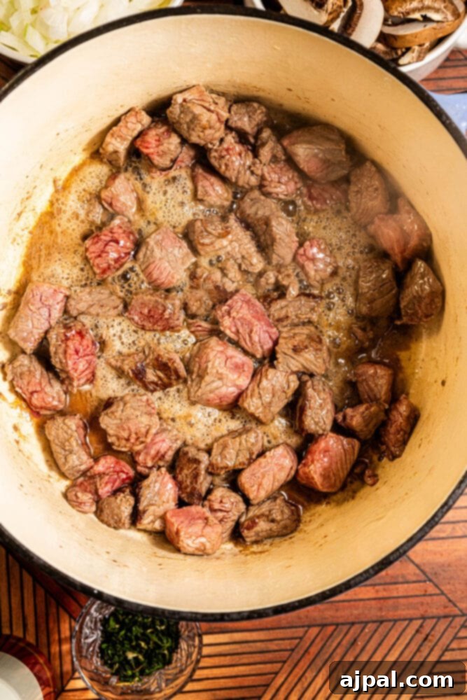 Hearty Beef and Potato Beer Stew 6 Cubed stew meat being seared in a hot Dutch oven to develop a flavorful crust.