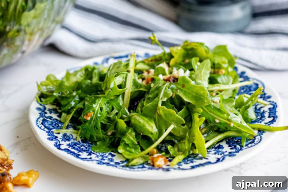 A vibrant cranberry salad featuring fresh arugula and crunchy walnuts.
