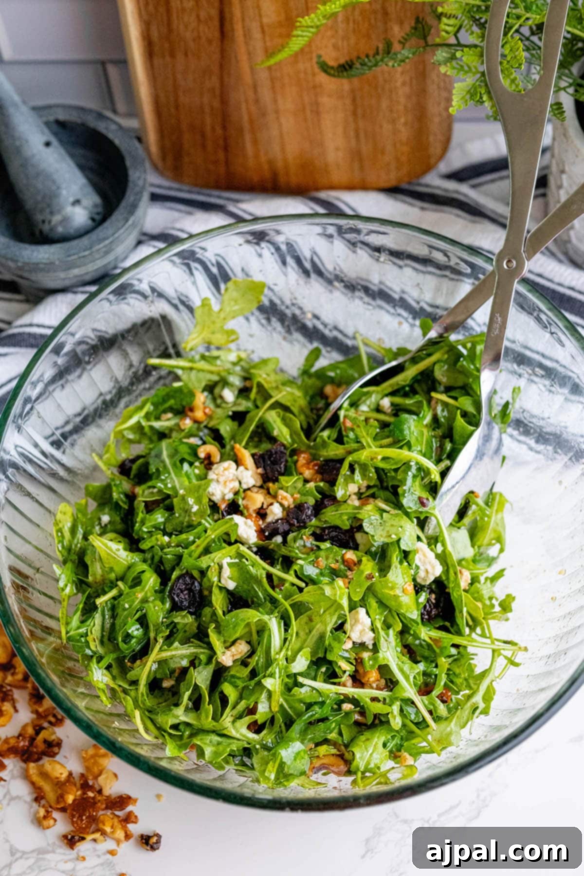 Arugula salad with walnuts, dried cranberries, and crumbled gorgonzola cheese.