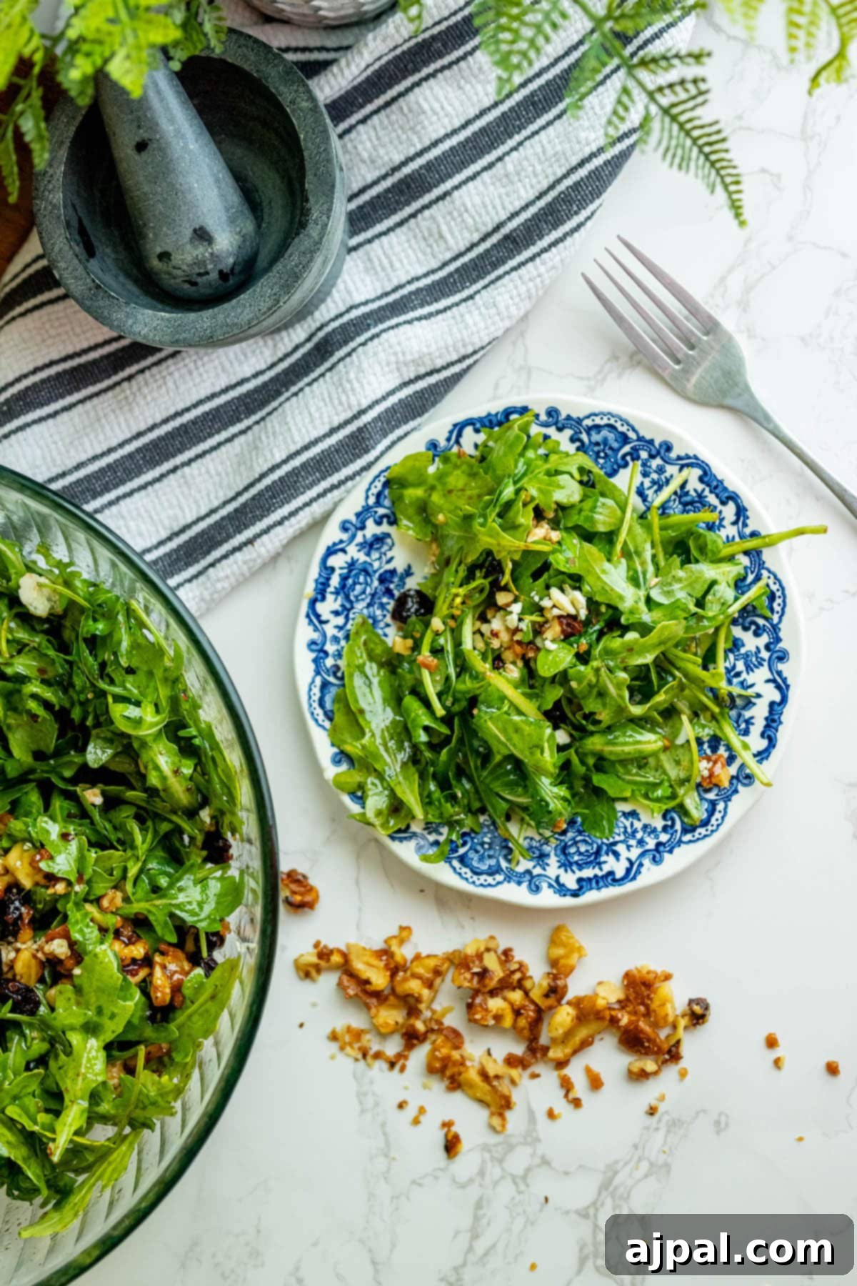 Arugula salad with walnuts, beautifully presented for a meal.