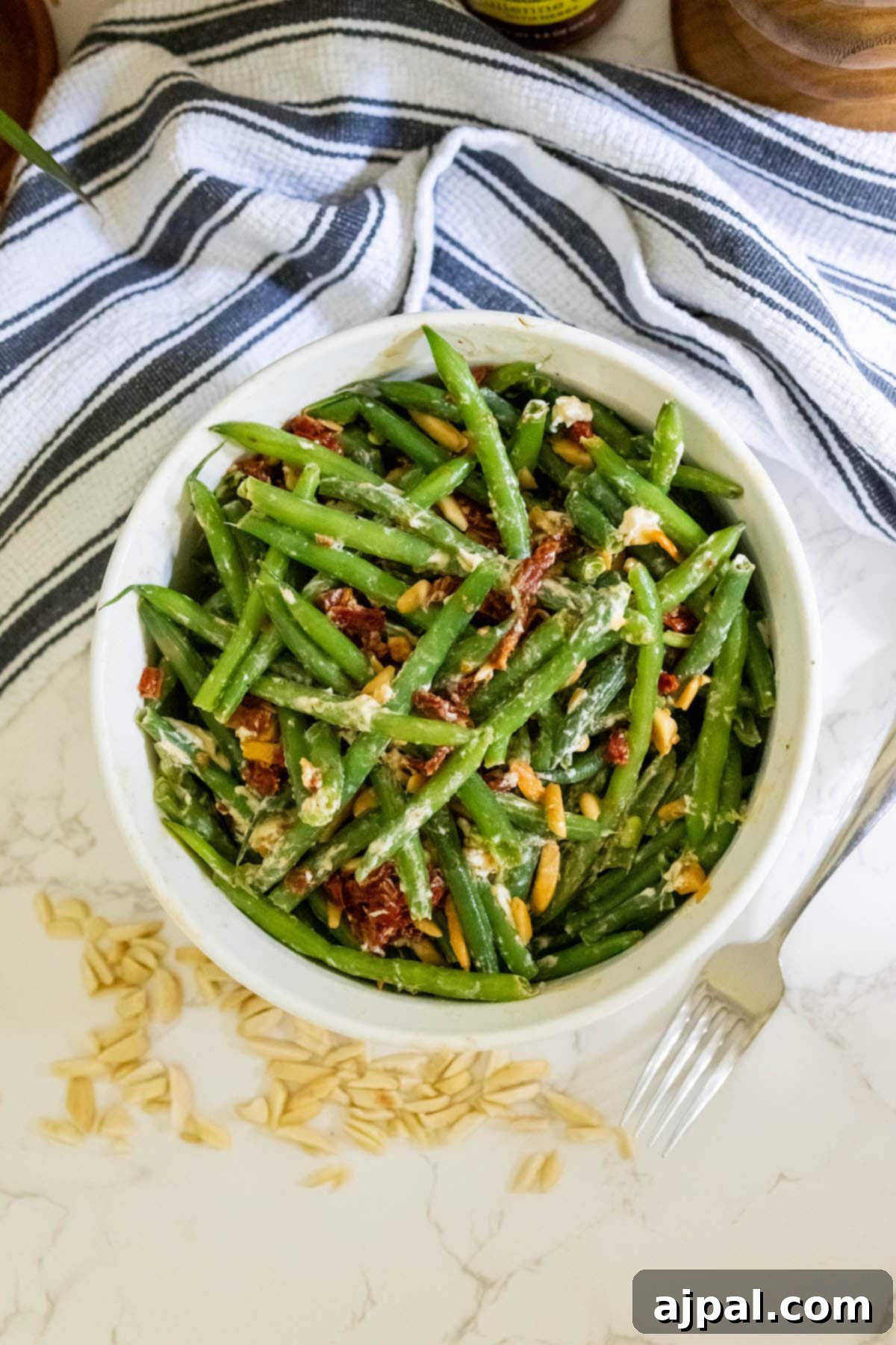 Sun-Dried Tomato & Parmesan Green Beans 4 Green bean salad with cheesy sun-dried tomato, slivered almonds around the bottom