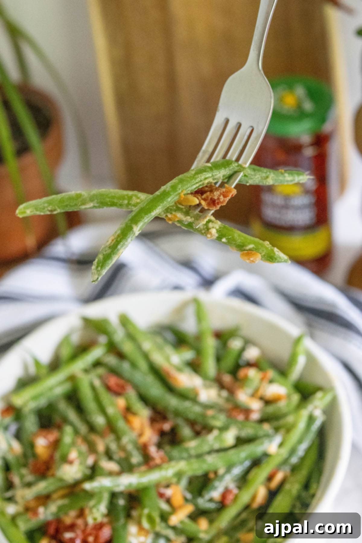 Sun-Dried Tomato & Parmesan Green Beans 8 Green beans in a white bowl.