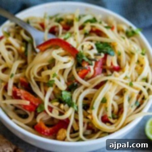Thai peanut noodles in a white bowl with a fork, miso noodle salad.