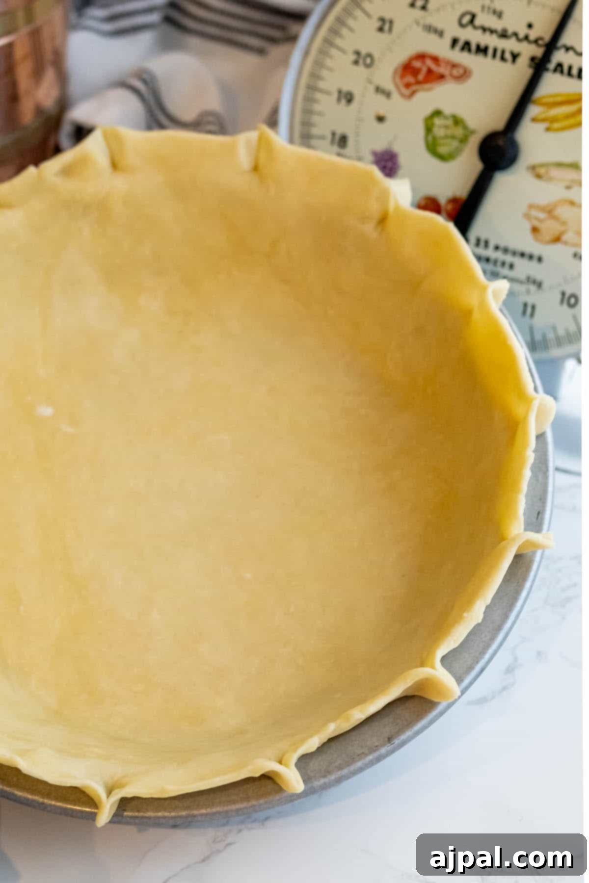 An easy pie crust is being made in a pie pan.