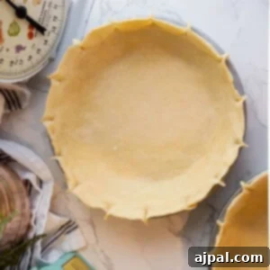 Two easy pie crusts on a marble countertop.