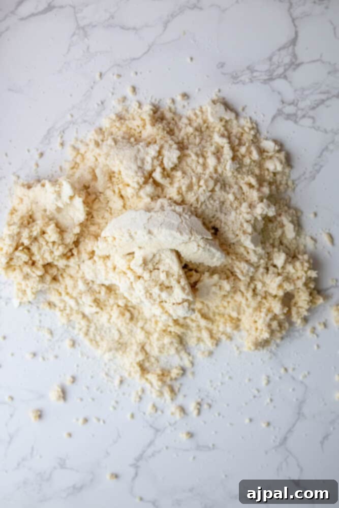 A mound of flour on a marble table for easy pie crust.