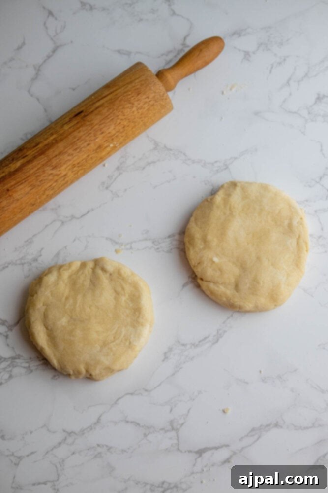 Foolproof Pie Crust 9 Easy pie crust and rolling pin on a marble table.