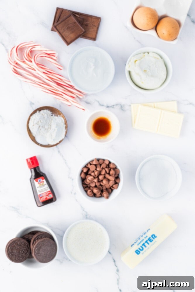 Peppermint Bark Cheesecake 5 Assorted ingredients for a chocolate peppermint cheesecake including chocolate chips, candy canes, and extracts, arranged on a marble surface.