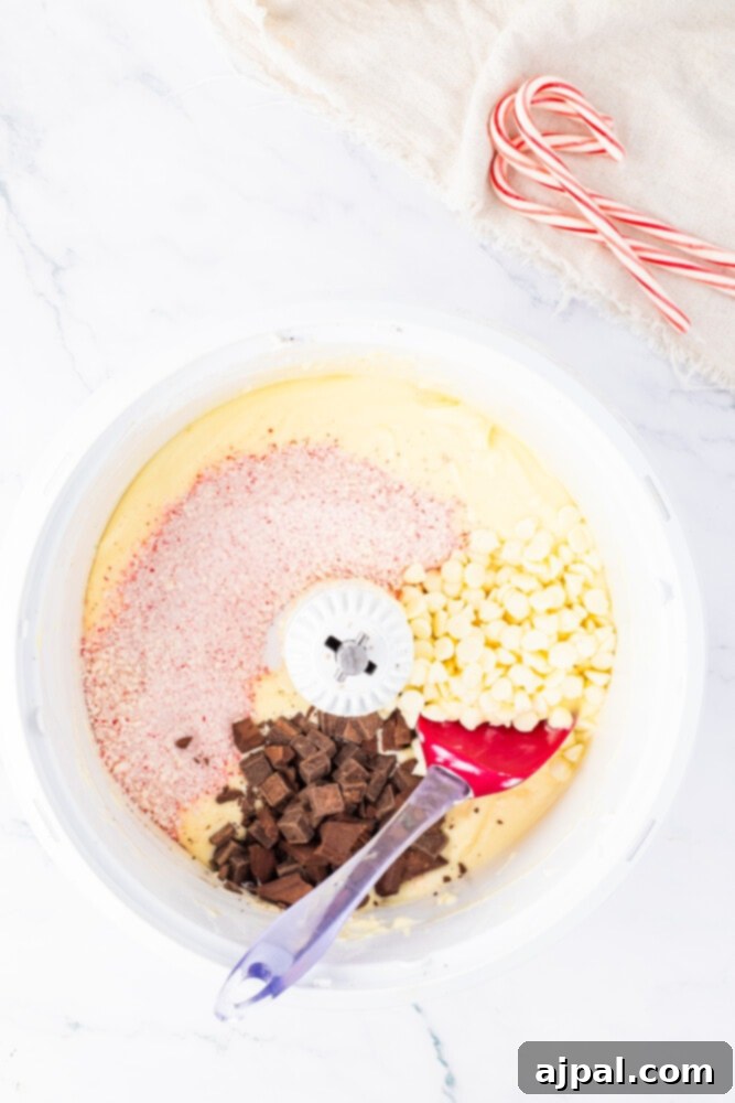 Peppermint Bark Cheesecake 8 A selection of ingredients, including whole and crushed candy canes, chocolate pieces, and other baking components, in bowls on a wooden table.