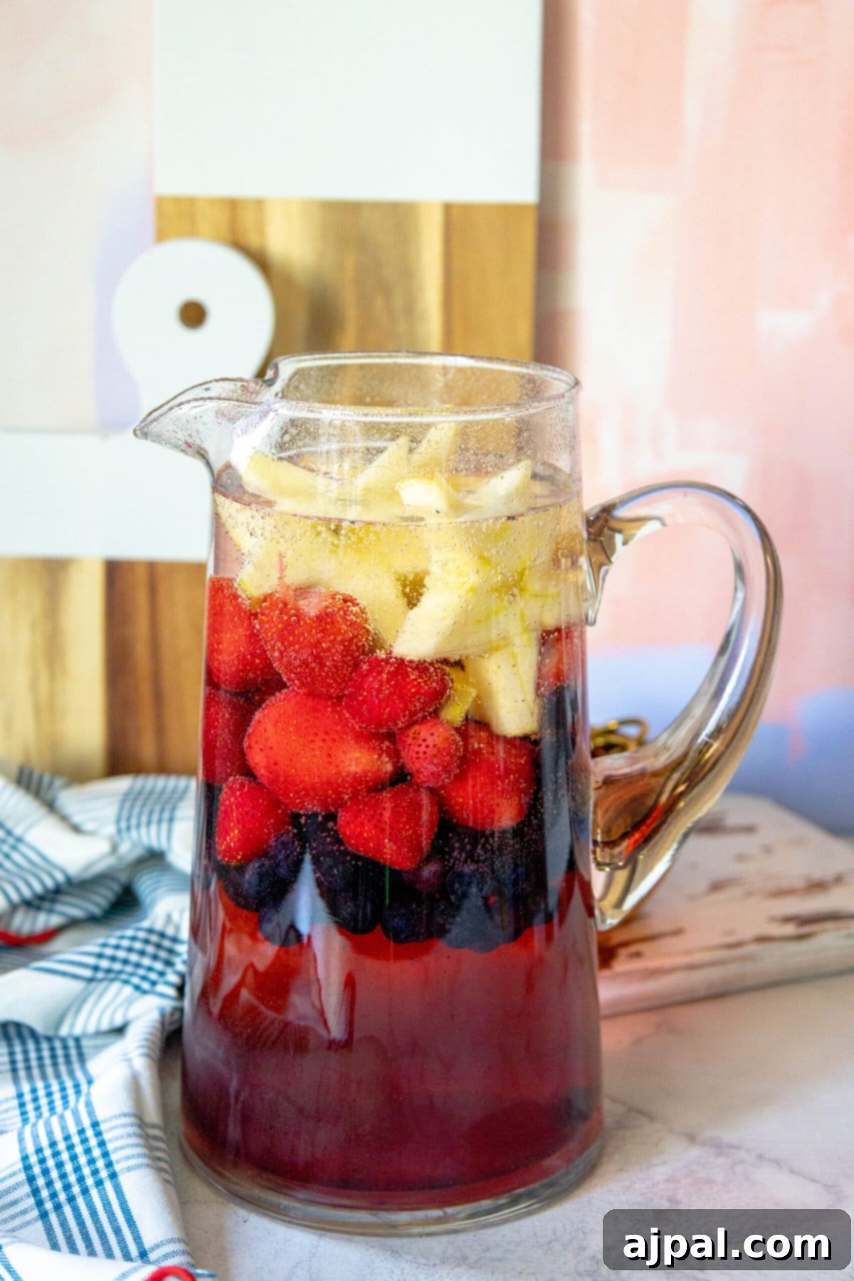 Stars and Stripes Celebration Punch 6 sprite, red white and blue fruit and apple juice in a pitcher