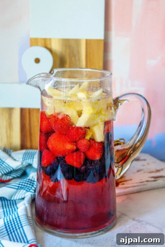 Stars and Stripes Celebration Punch 7 A pitcher filled with easy patriotic punch recipe made with berries and fruit.