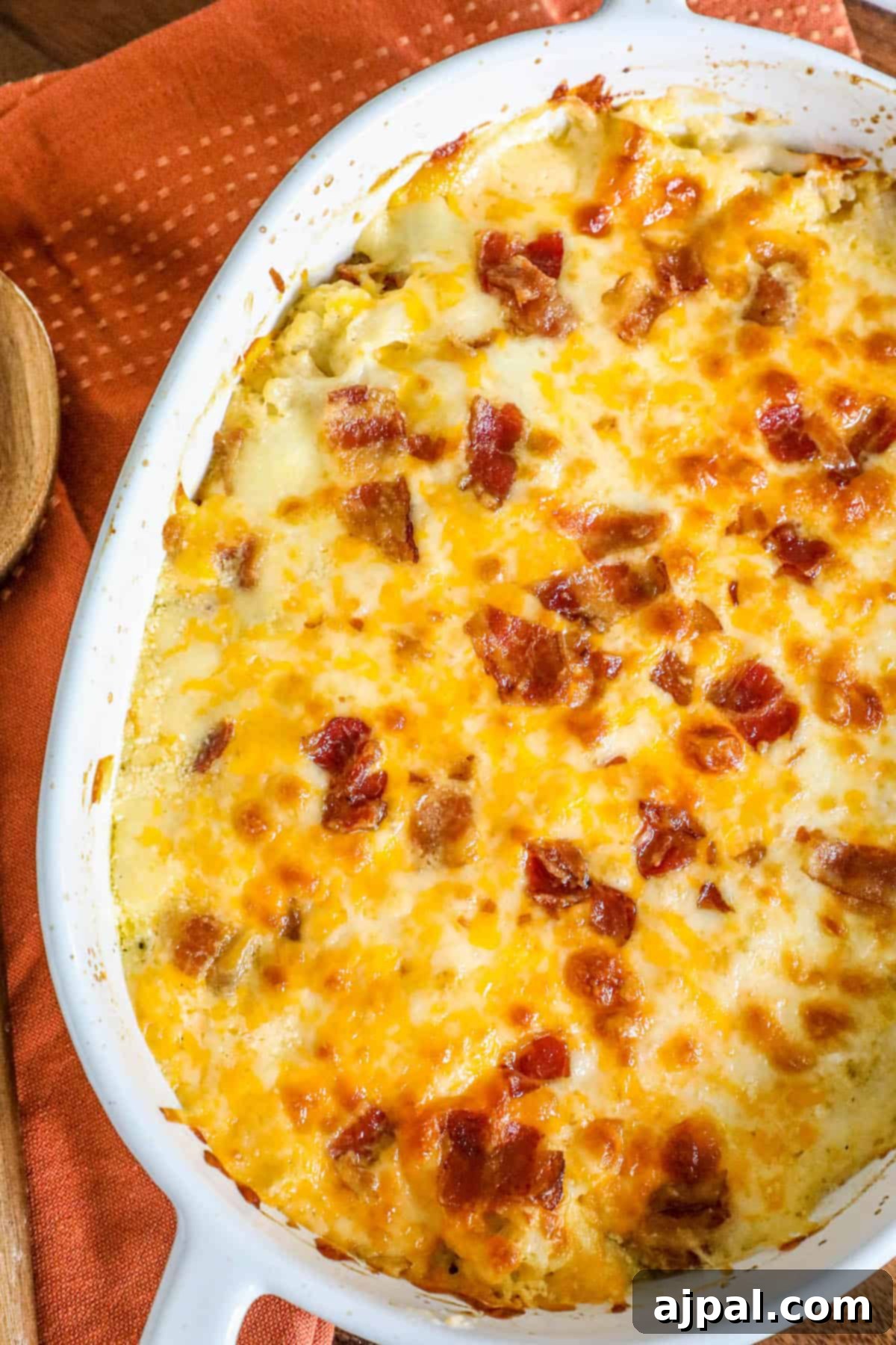 A vibrant broccoli and cauliflower casserole, studded with crispy bacon and covered in rich melted cheese.
