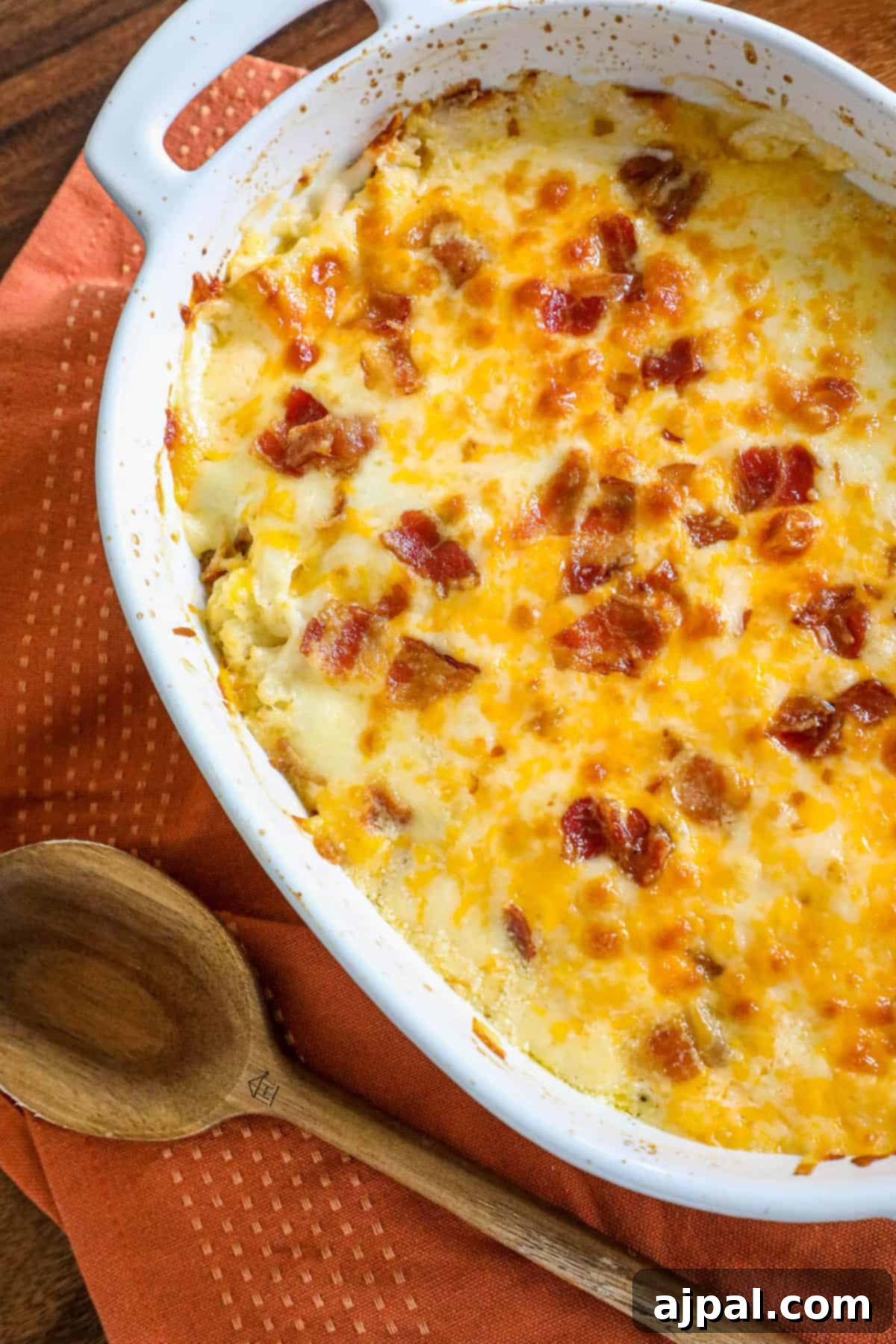 A beautifully baked broccoli and cauliflower casserole, garnished with crispy bacon and fresh herbs.