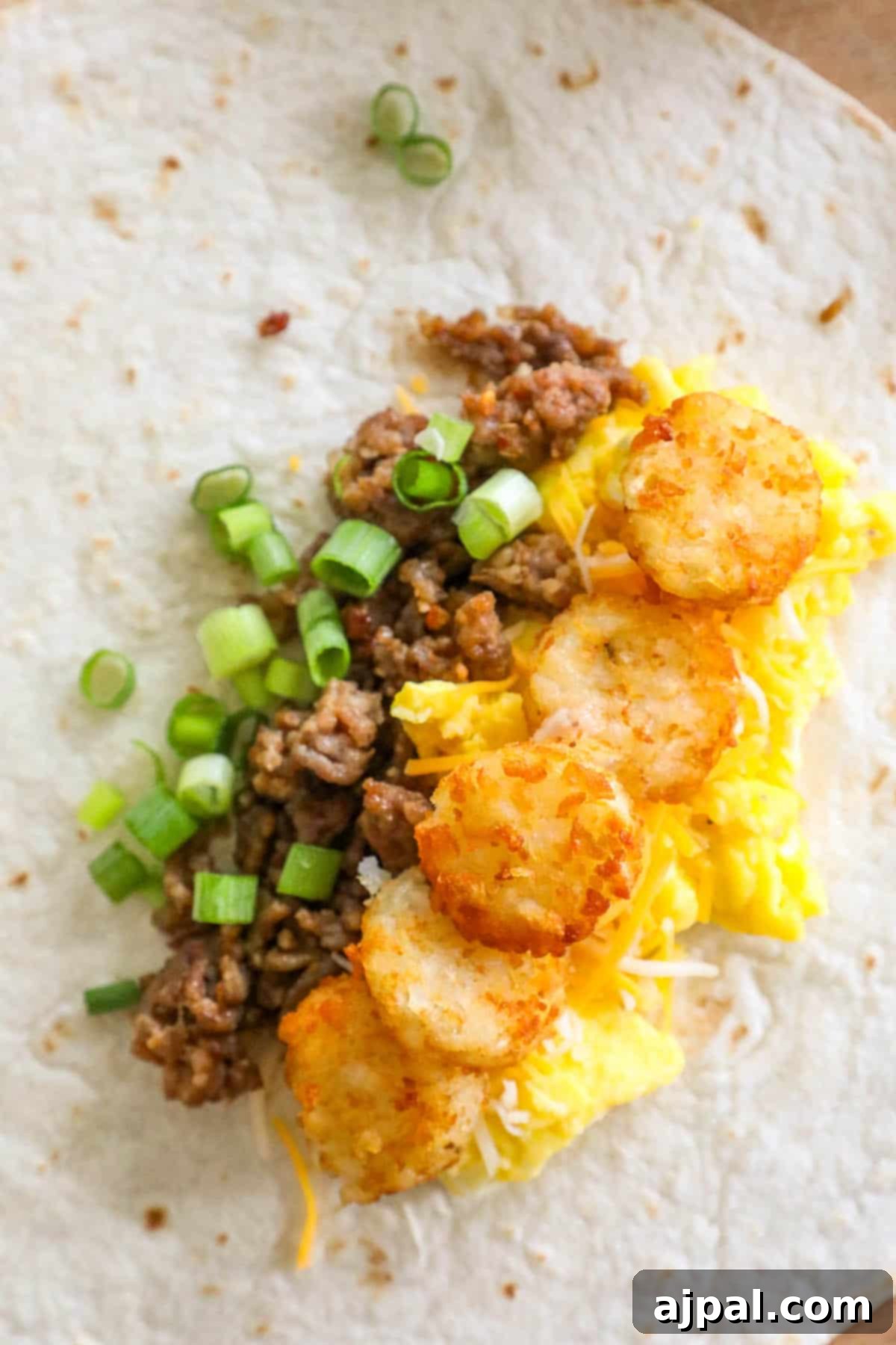Grab-and-Go Breakfast Burritos 4 A single, perfectly rolled freezer breakfast burrito, revealing its delicious cross-section of eggs, cheese, and other fillings.