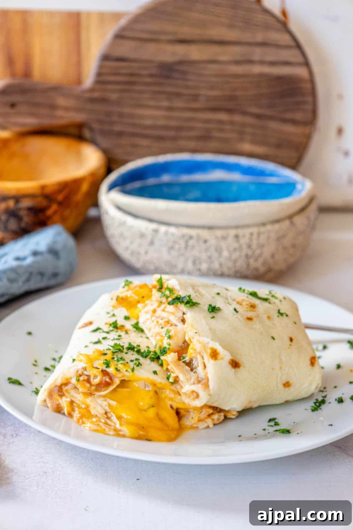 Oven-Baked Chicken Chimichangas 3 Baked chicken chimichanga on a white plate, close-up.