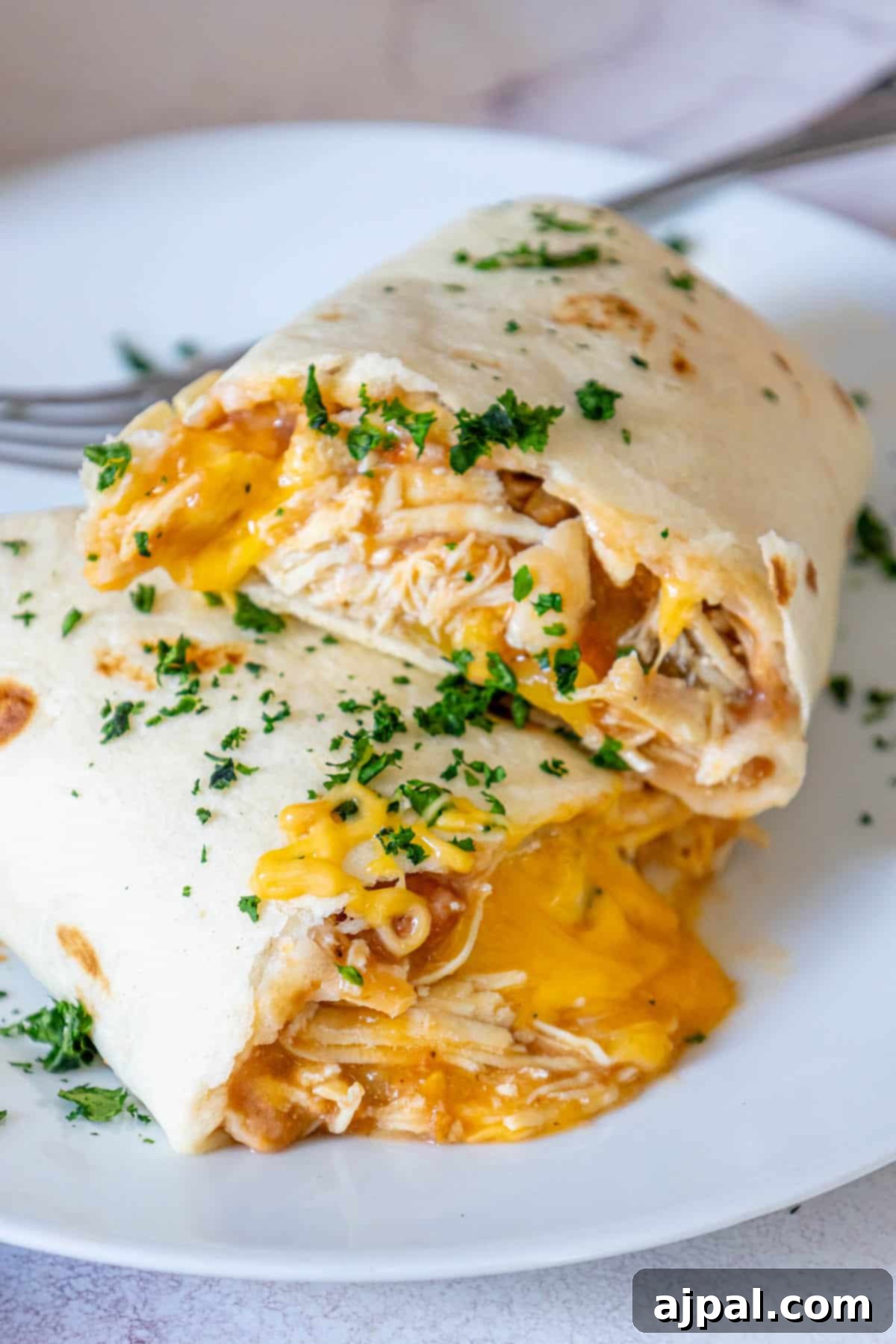 Oven-Baked Chicken Chimichangas 17 Baked chicken chimichangas with a side of creamy sauce.