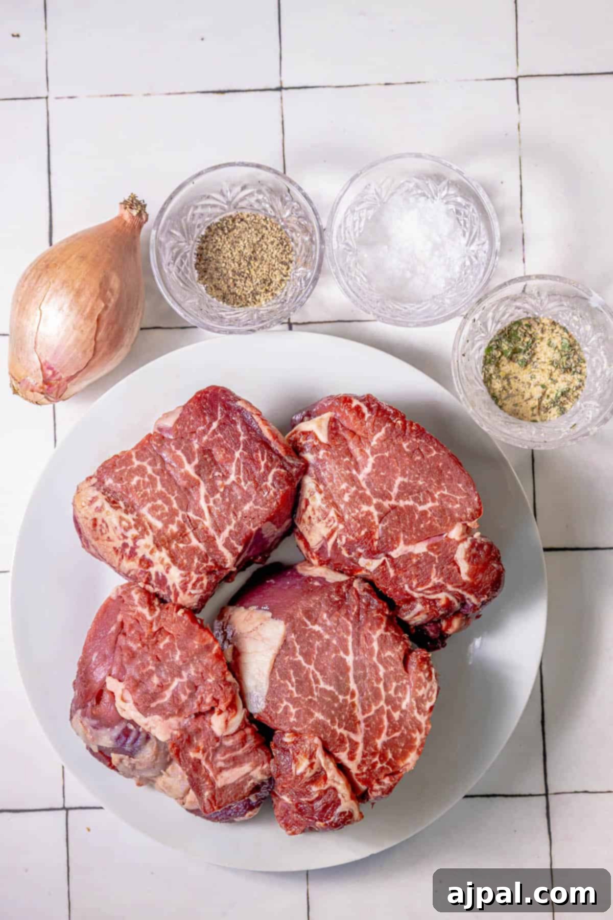 Perfectly Reverse Seared Filet Mignon 5 A plate of Reverse Sear Filet Mignon on a tiled floor.
