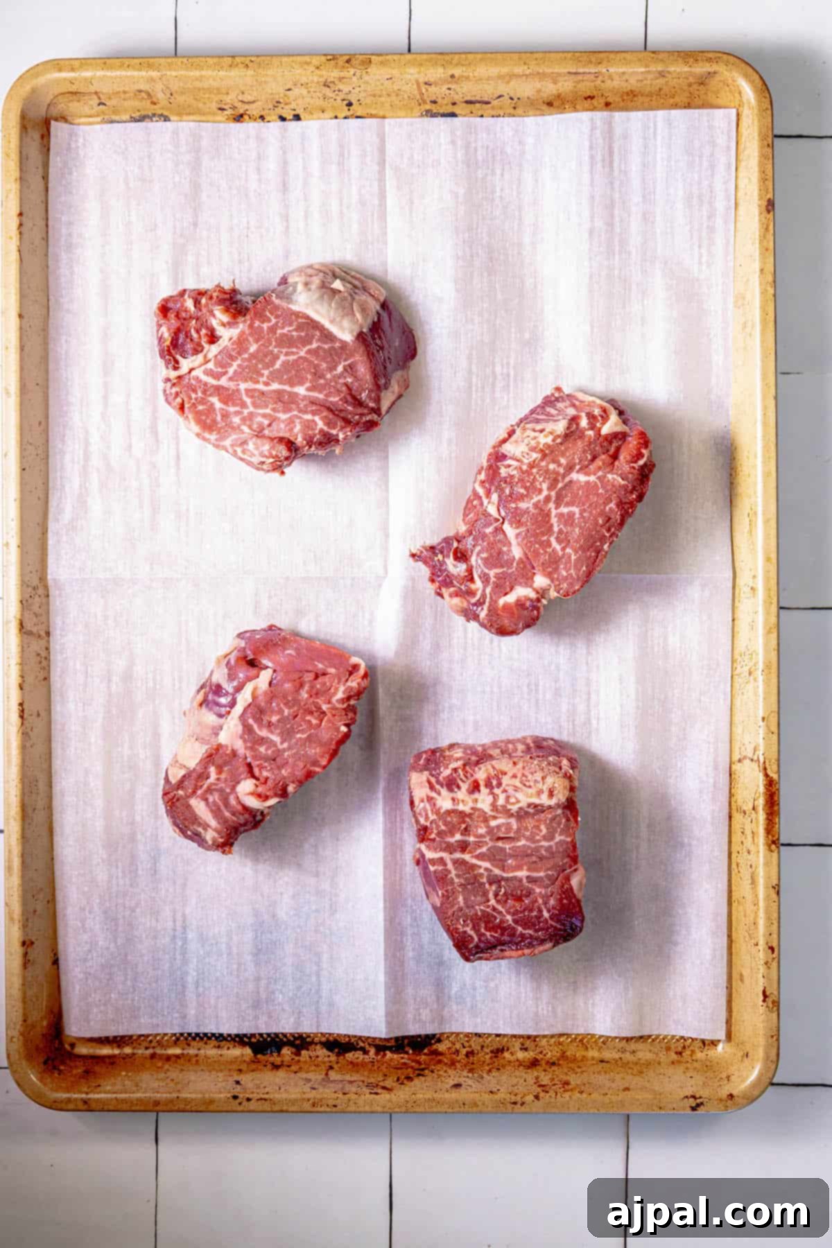 Perfectly Reverse Seared Filet Mignon 6 Four pieces of Reverse Sear Filet Mignon on a tray on a tiled floor.