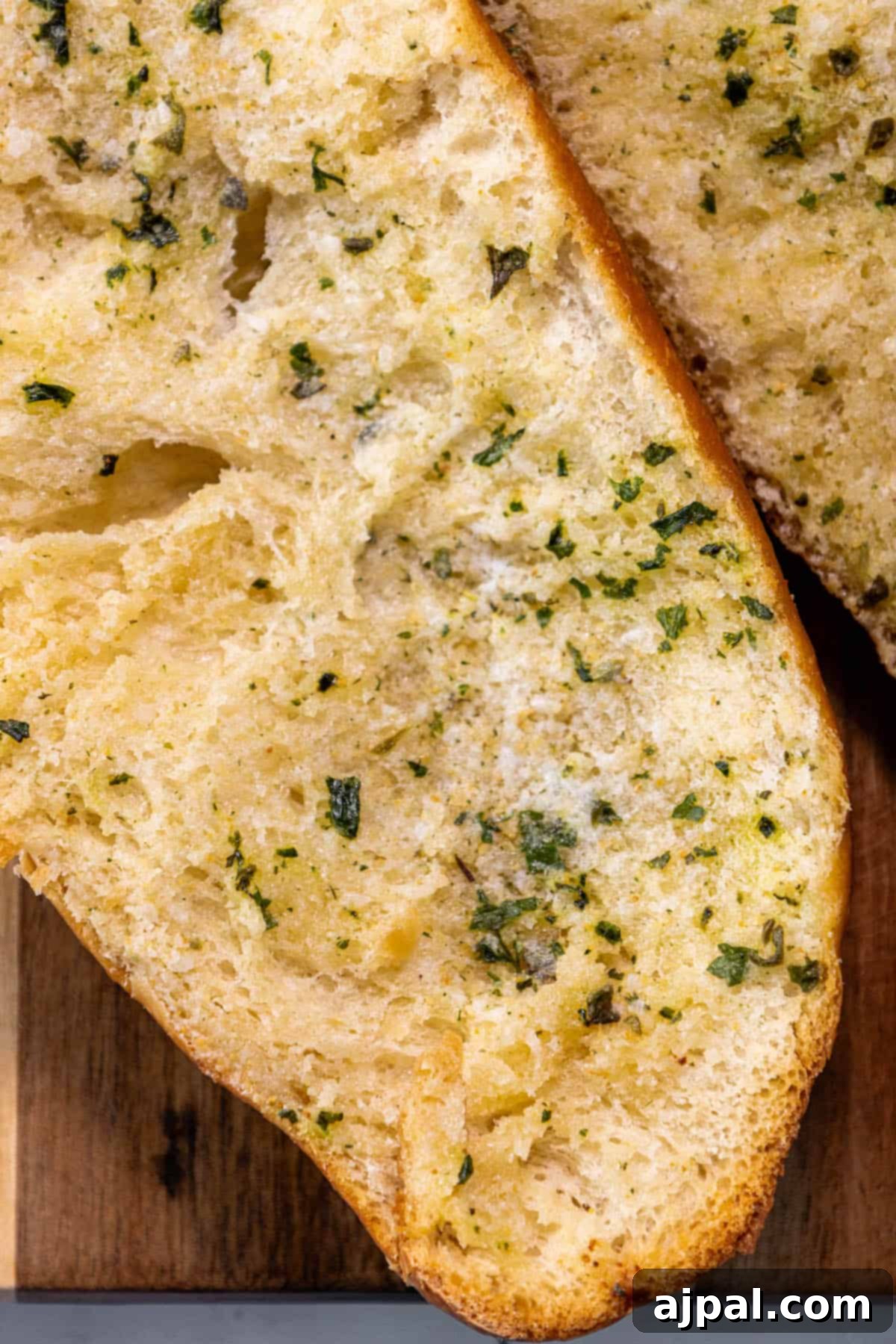 A slice of bread is sitting on a cutting board.