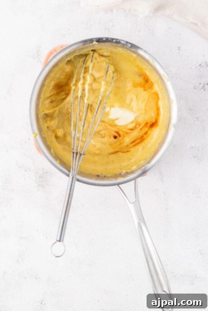 Festive Eggnog Tart 11 A whisk with batter in it.