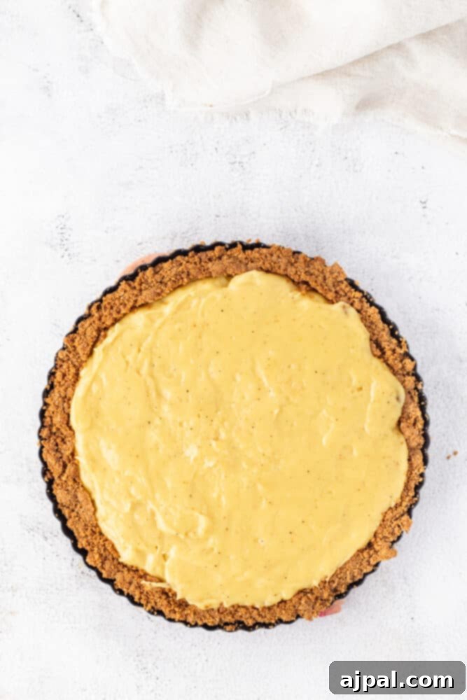 Festive Eggnog Tart 13 A yellow Eggnog Tart on a white surface.