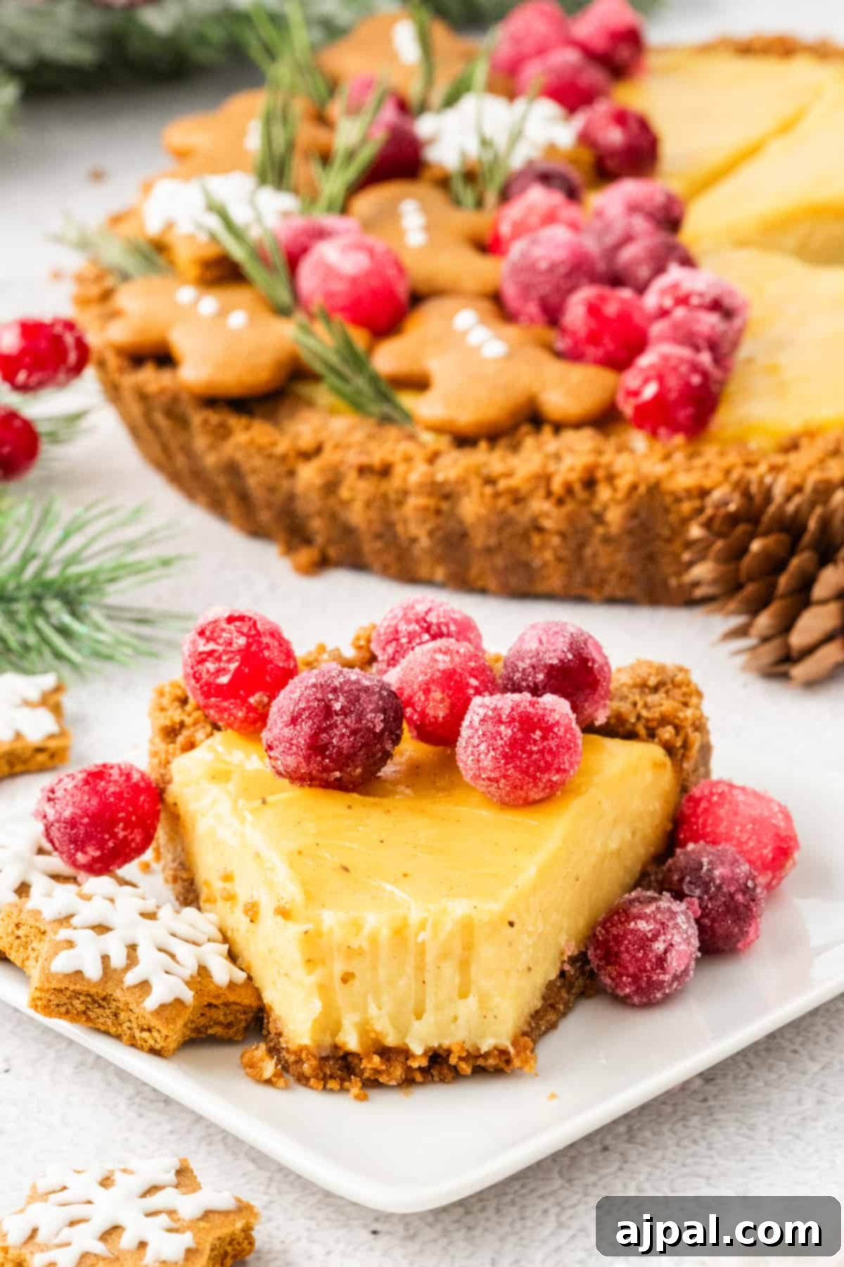 Festive Eggnog Tart 16 A slice of eggnog tart with cranberries and gingerbread cookies on a plate.