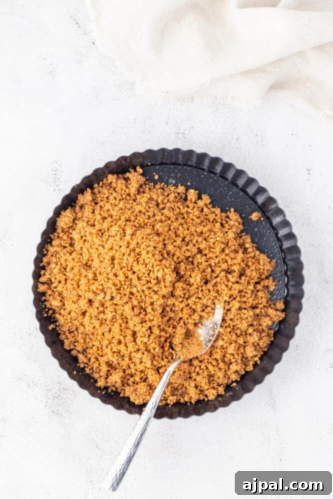 Festive Eggnog Tart 7 A bowl of brown sugar with a spoon on top, alongside an eggnog tart.
