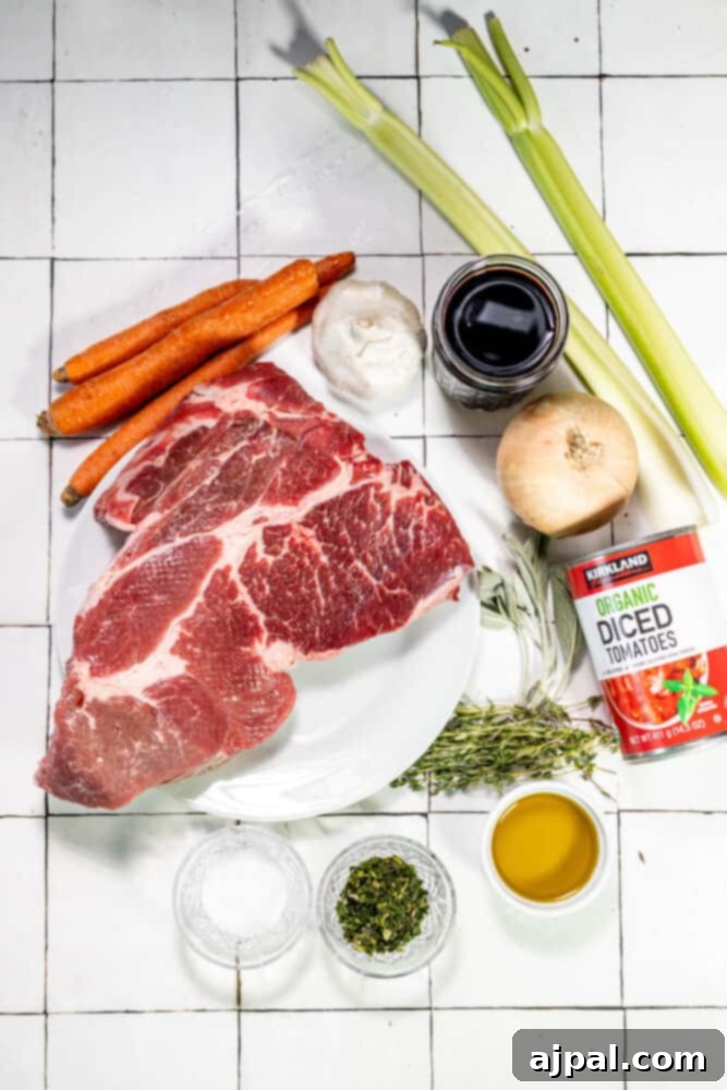 A plate with Perfect Chuck Roast and tender vegetables, showcasing a beautifully cooked meal.