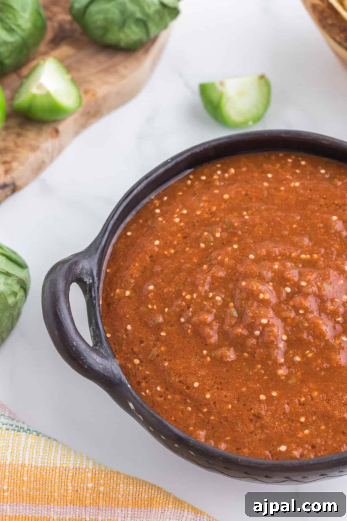 Smoky Chipotle Blaze 13 A bowl of spicy Mexican salsa, infused with the smoky essence of chipotle peppers, sits ready with crisp tortilla chips for a perfect snack or appetizer.