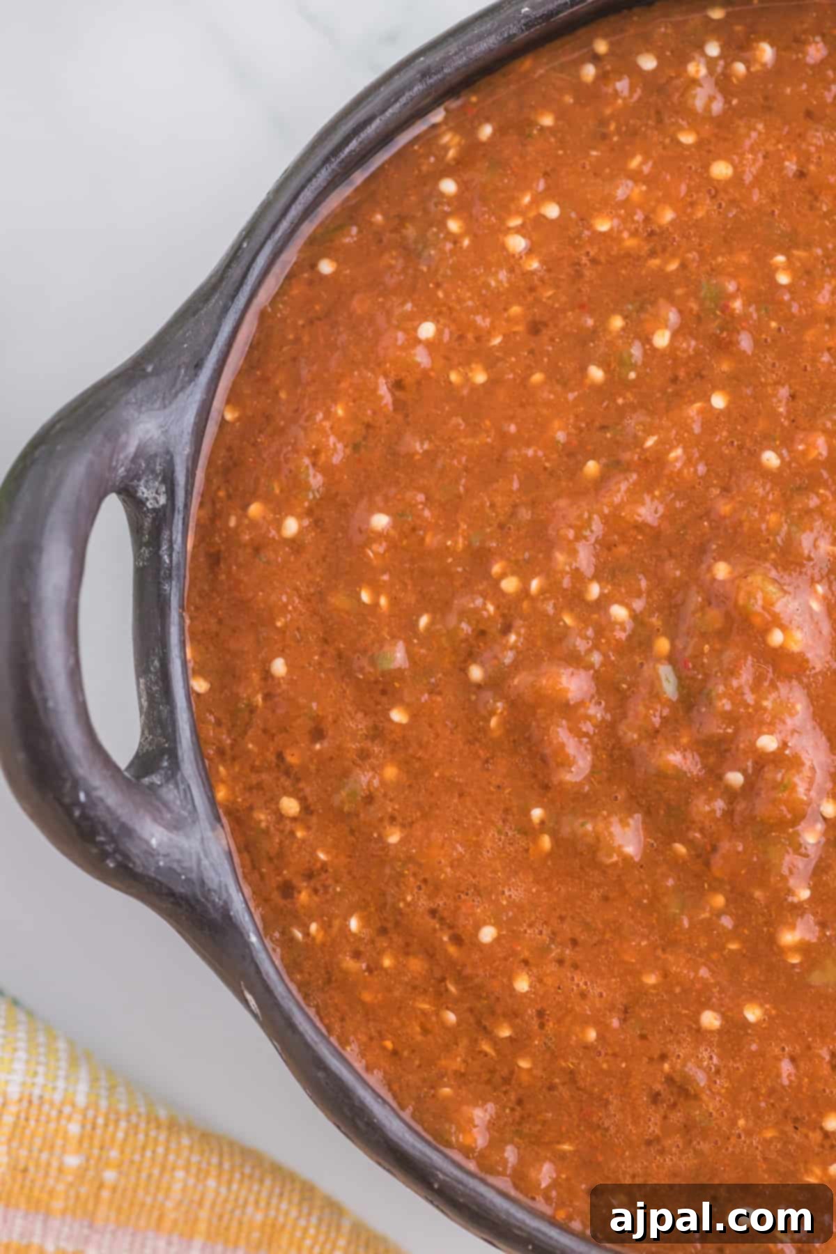 Smoky Chipotle Blaze 10 A beautifully presented bowl of Homemade Chipotle Salsa rests on a rustic wooden table, ready to be enjoyed.