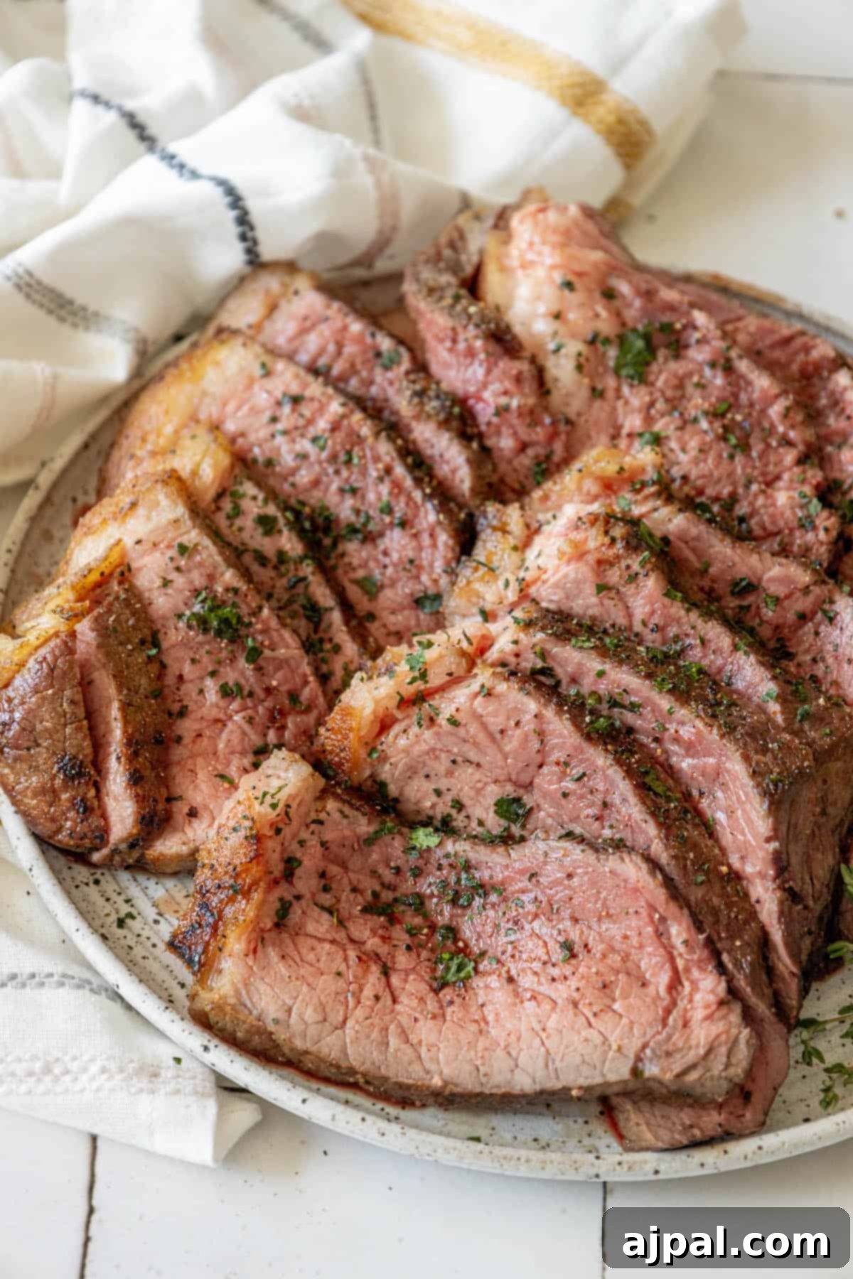 Bottom Round Roast with Herb Butter beautifully plated and ready to be enjoyed.