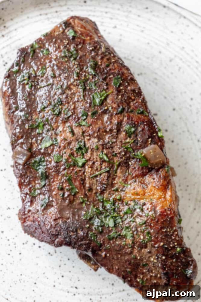 Bottom Round Roast with Herb Butter served on a plate.