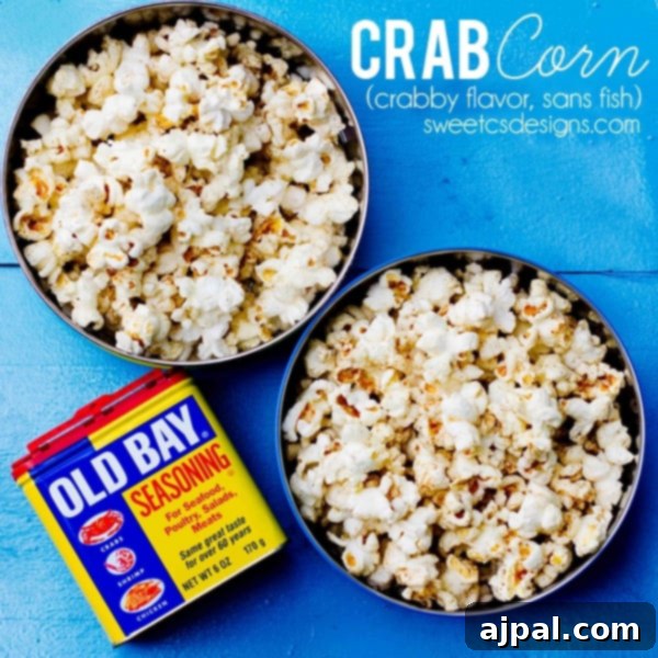 A bowl of freshly popped Old Bay seasoned popcorn with a small dish of Old Bay seasoning beside it, ready for a movie night snack.