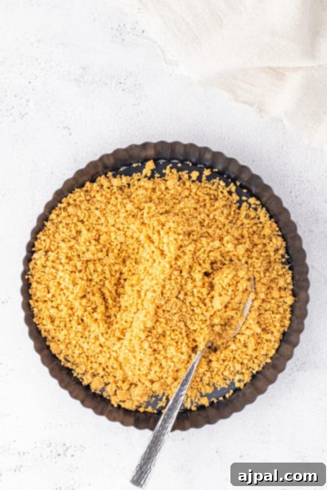 Silken White Chocolate Blackberry Tart 8 A bowl of yellow rice on a white background, representing one of the tart's filling components.