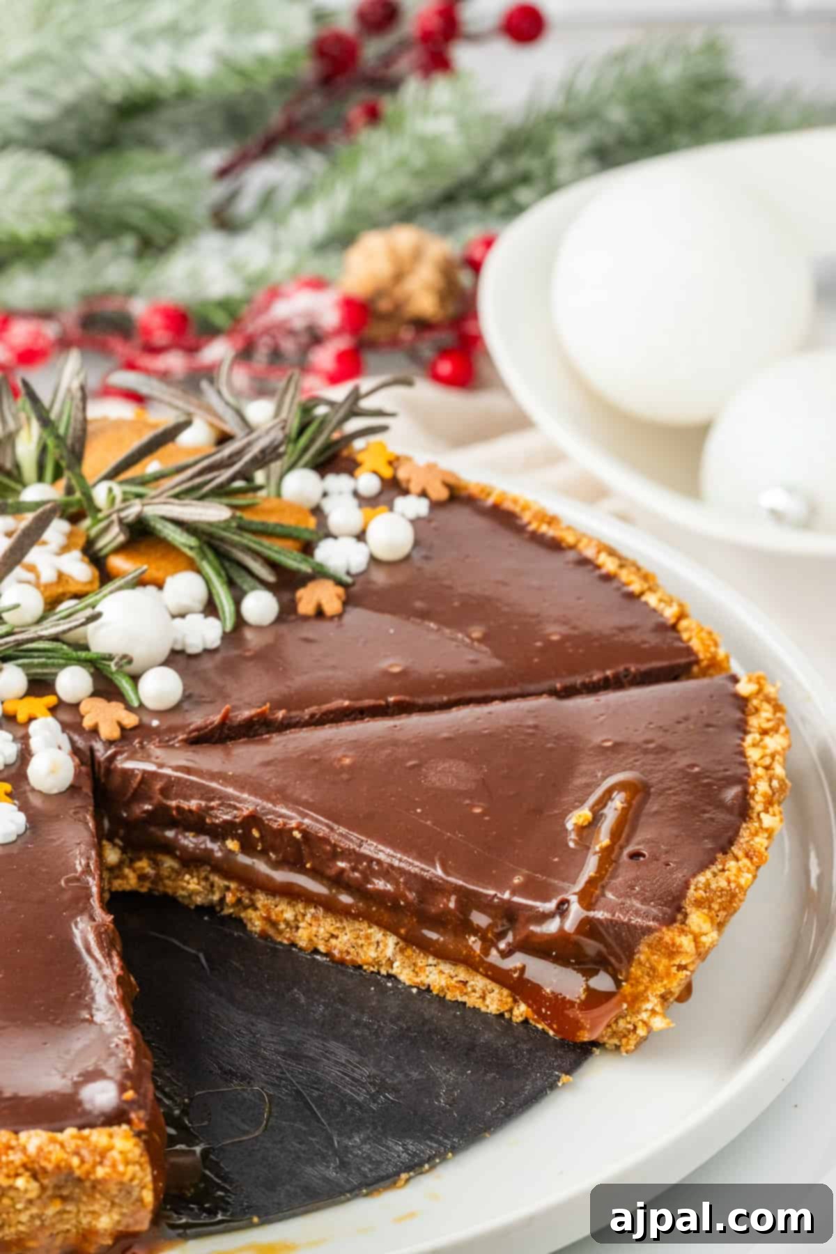 A delectable Gingerbread Chocolate Tart with a perfect slice removed, showcasing its rich, layered interior.