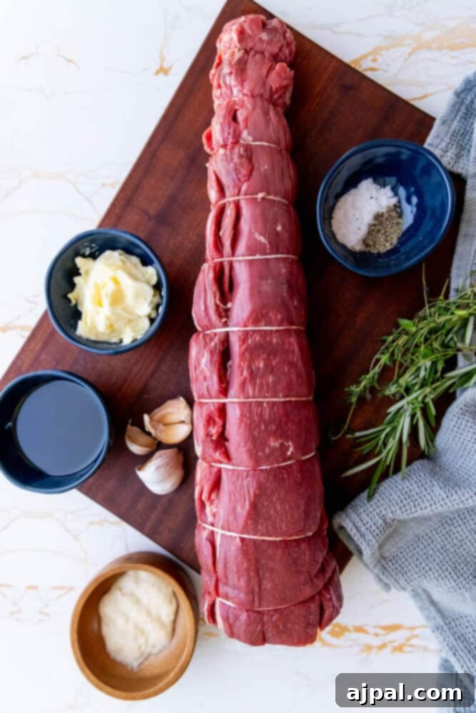 Garlic herb beef tenderloin on a cutting board, ready for cooking.