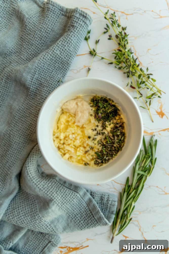 A bowl of fresh herbs and garlic, ready to be mixed into a sauce.