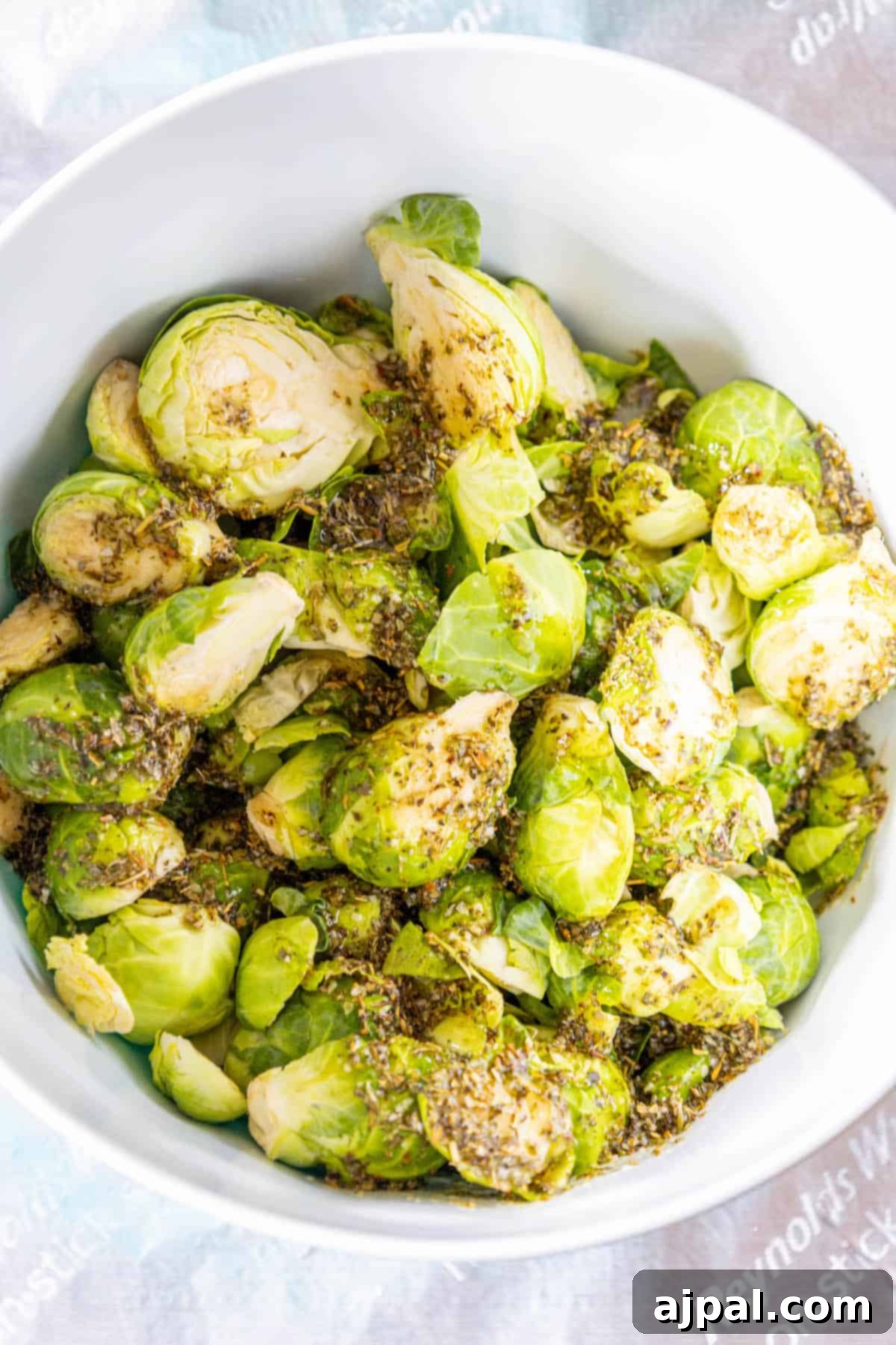 Caramelized Brussels Sprouts and Sweet Onions 4 Roasted Brussels sprouts in a white bowl with herbs.