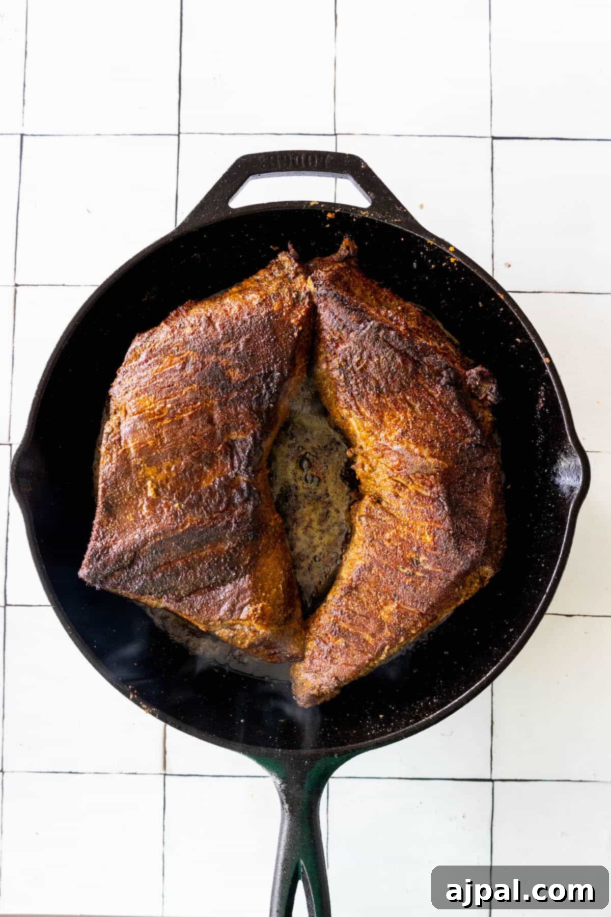 A reverse seared tri tip steak cooked in a cast iron skillet.