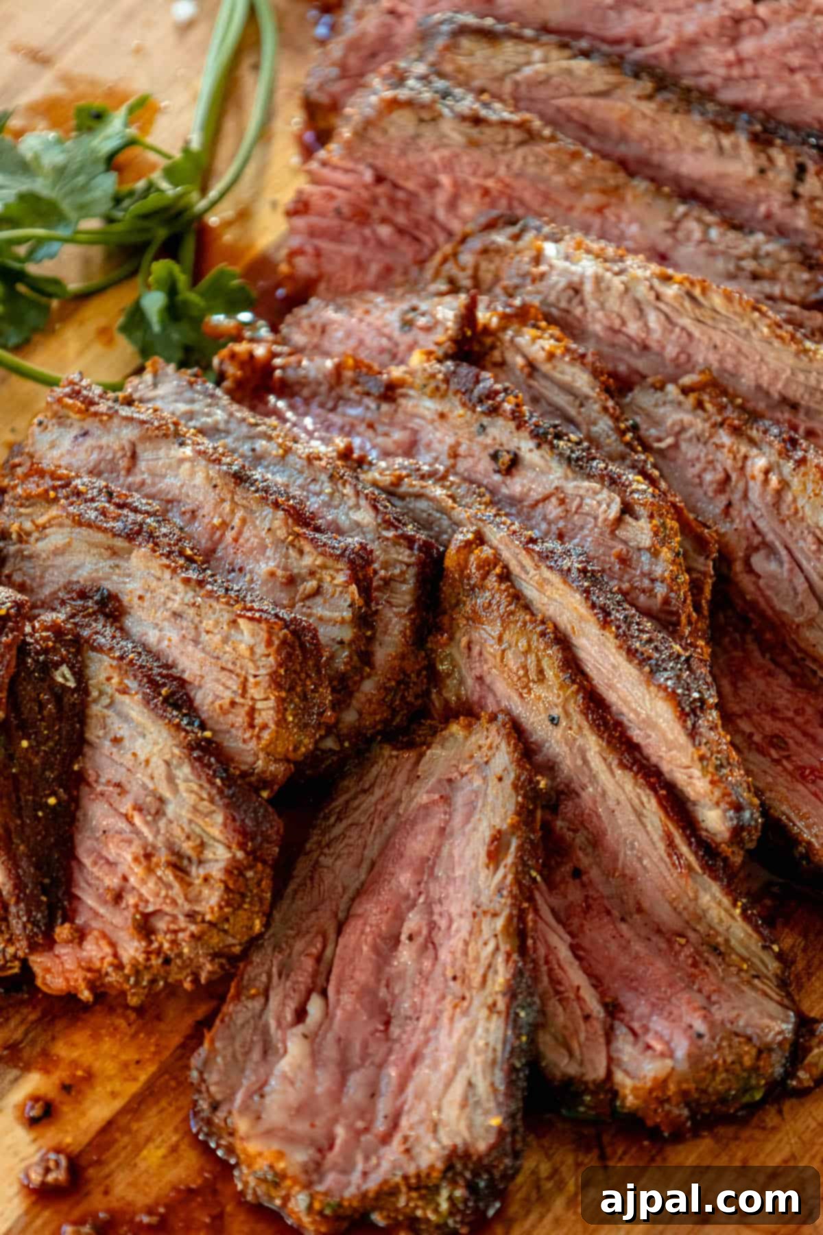 A reverse seared tri tip steak on a cutting board.