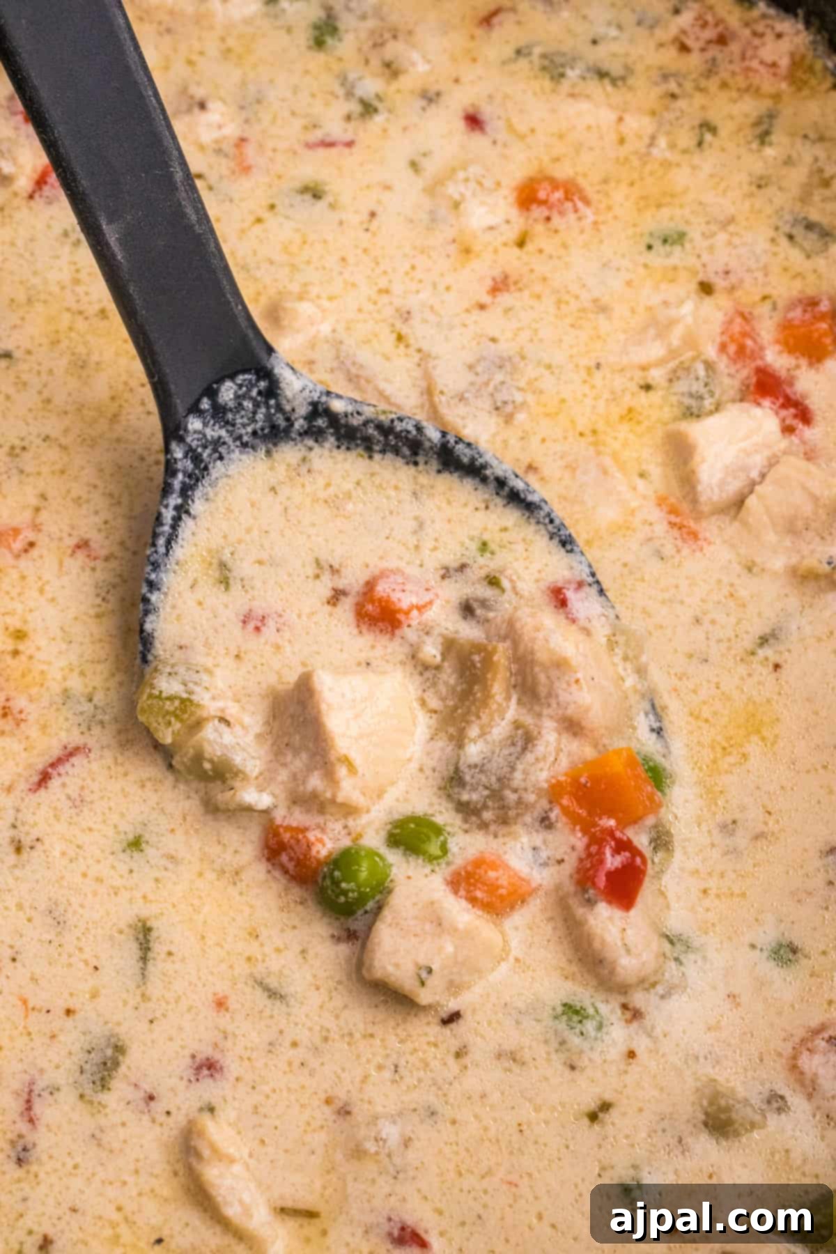 Easy Slow Cooker Chicken a la King 3 Slow Cooker Chicken Chowder in a skillet with a spoon.