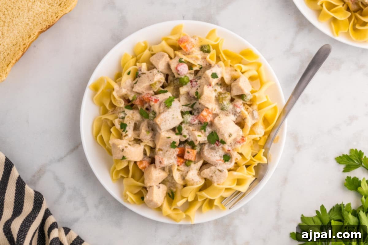 Easy Slow Cooker Chicken a la King 4 Slow cooker chicken a la king with vegetables served over pasta.
