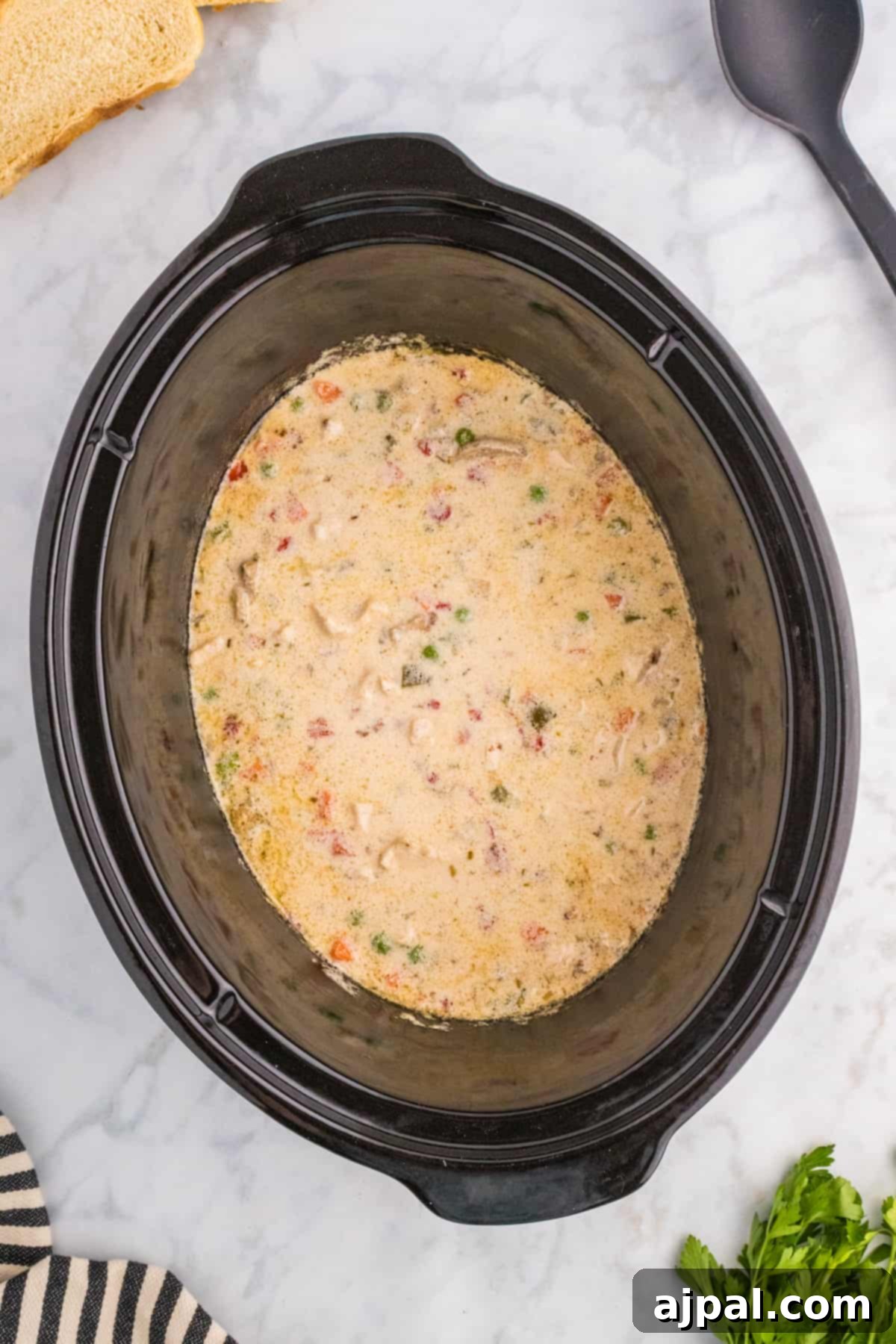 Easy Slow Cooker Chicken a la King 10 A slow cooker with a bowl of soup.