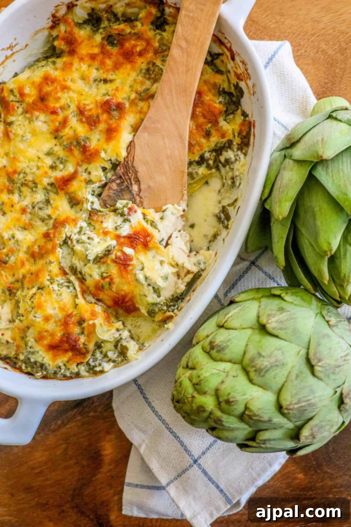 Creamy Chicken, Spinach & Artichoke Bake 6 A vibrant and cheesy close-up of the Creamy Chicken Spinach Artichoke Casserole, showcasing its rich texture and appetizing colors.