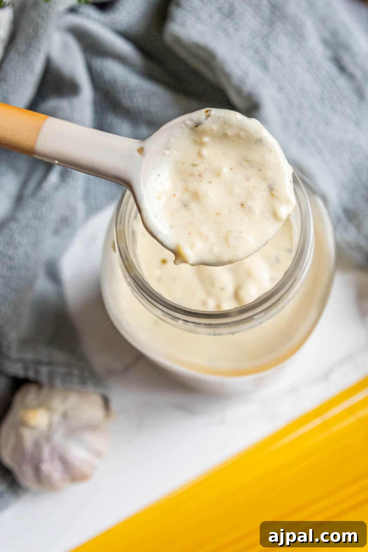 Perfect Homemade Alfredo Sauce 10 A pristine glass jar proudly displaying the best homemade Alfredo sauce, rich and creamy, perfect for convenient storage and adding a touch of gourmet to any meal.